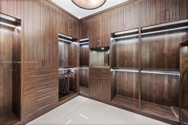 spacious closet with light tile patterned floors