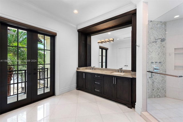 bathroom featuring vanity, french doors, crown molding, tile patterned flooring, and a tile shower