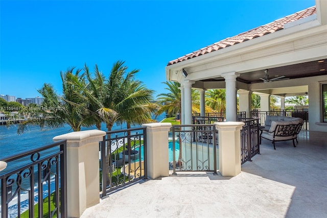 view of patio / terrace with ceiling fan and a water view