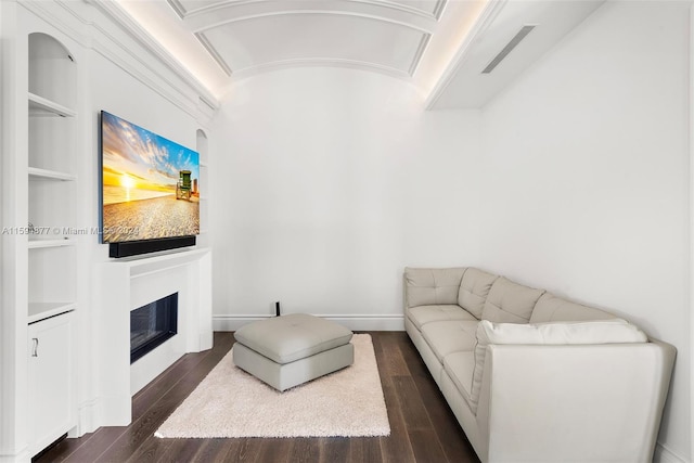 living room featuring dark hardwood / wood-style floors and ornamental molding