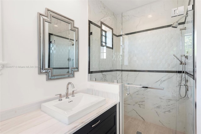 bathroom with tile patterned floors, vanity, and a shower with shower door