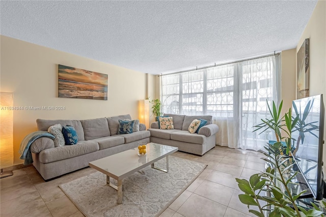 living room featuring light tile patterned floors and a textured ceiling