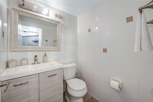 bathroom with tile walls, vanity, backsplash, and toilet