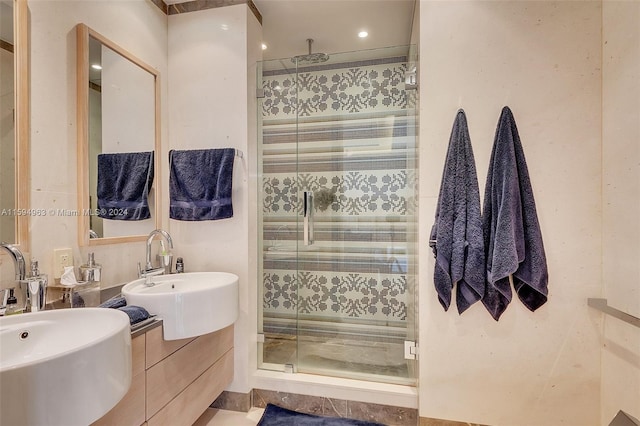 bathroom with an enclosed shower and sink