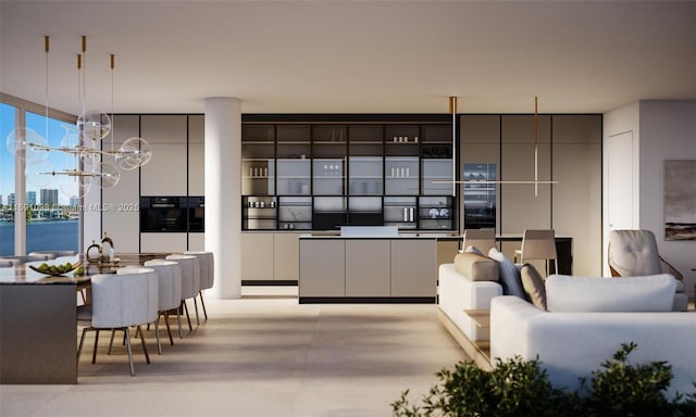 kitchen featuring expansive windows, white cabinets, and a water view