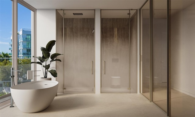 bathroom featuring a wall of windows and independent shower and bath