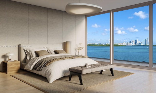 bedroom with access to exterior, hardwood / wood-style flooring, a wall of windows, and a water view