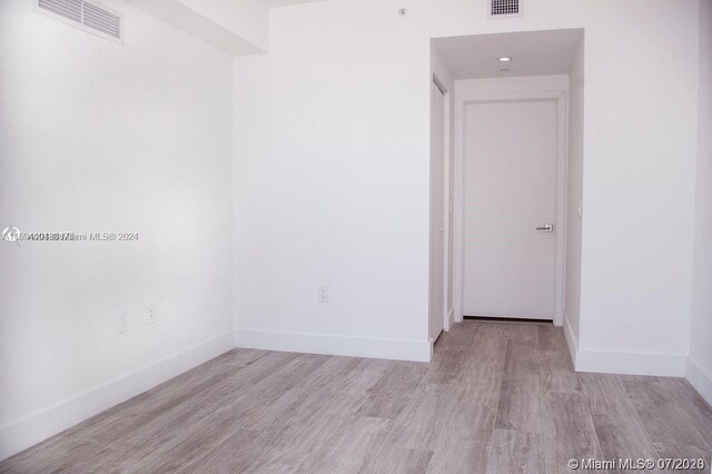 unfurnished room with hardwood / wood-style floors