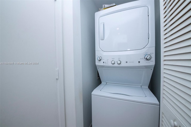 laundry area featuring stacked washer / drying machine