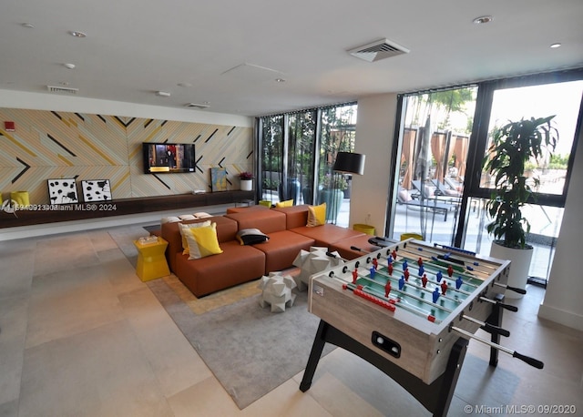 game room with tile floors and a wall of windows