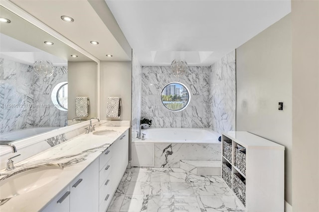 bathroom featuring vanity and tiled bath