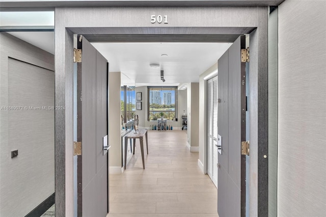 hallway with light hardwood / wood-style flooring