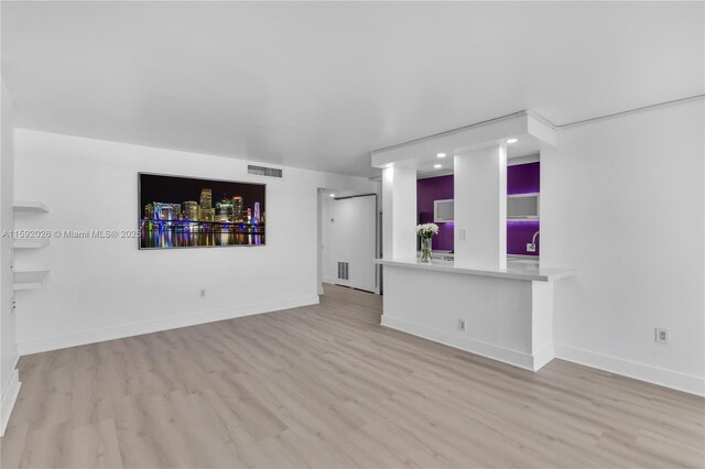 unfurnished living room with light wood-type flooring