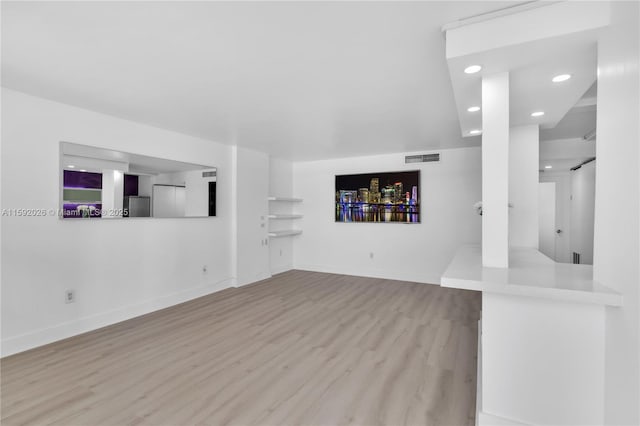 unfurnished living room with light wood-type flooring