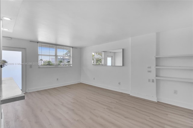 spare room with light hardwood / wood-style floors