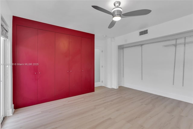 unfurnished bedroom featuring ceiling fan and light wood-type flooring