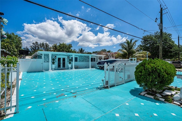 view of swimming pool with french doors