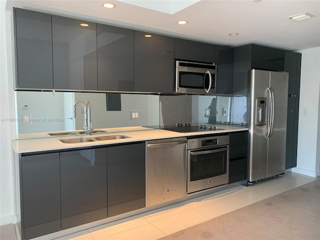 kitchen with sink, light tile flooring, and appliances with stainless steel finishes