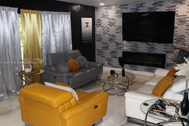 living room featuring brick wall and concrete flooring