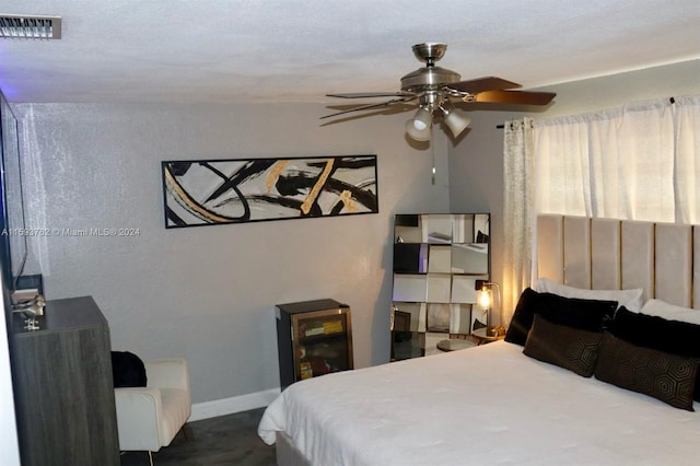 bedroom with a textured ceiling and ceiling fan