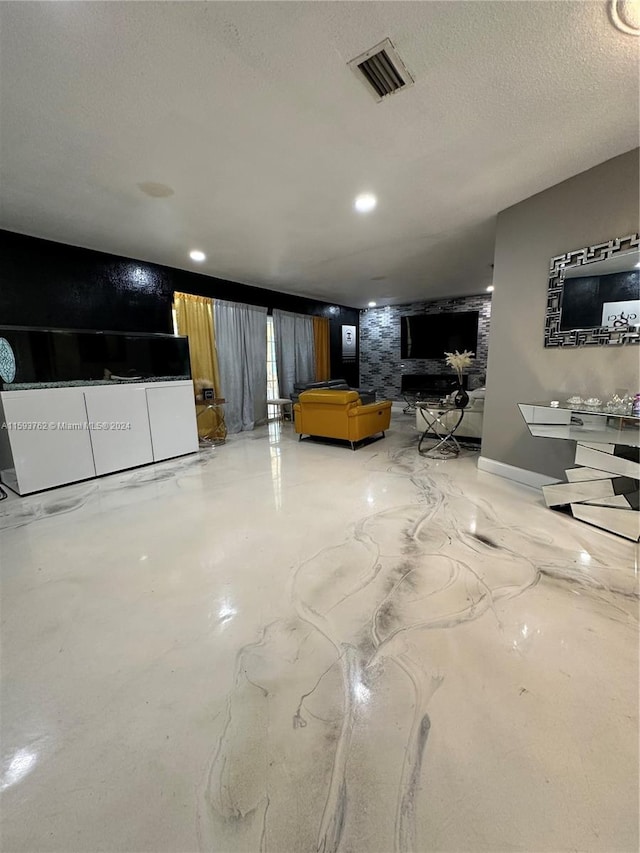 unfurnished living room with a textured ceiling