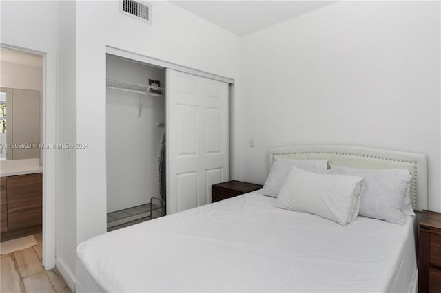 bedroom featuring a closet and wood-type flooring