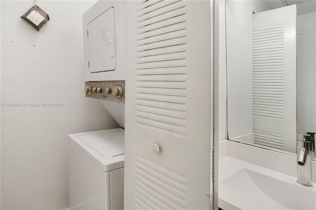 laundry area featuring stacked washer and clothes dryer