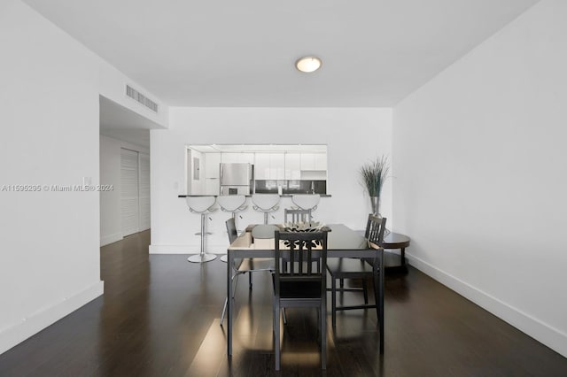 dining area featuring dark wood-type flooring