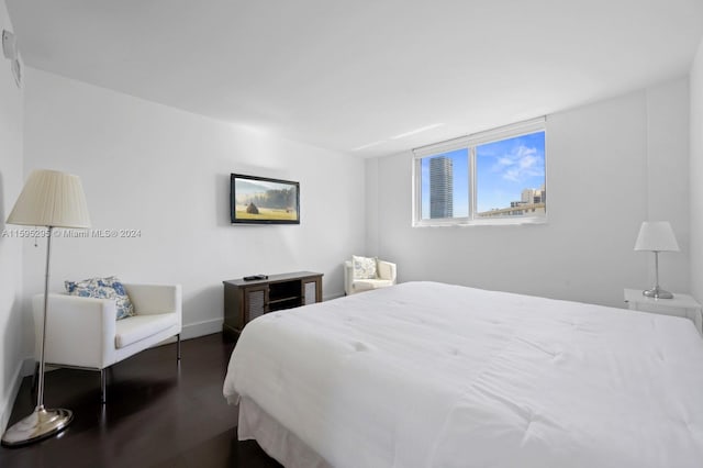 bedroom with dark wood-type flooring