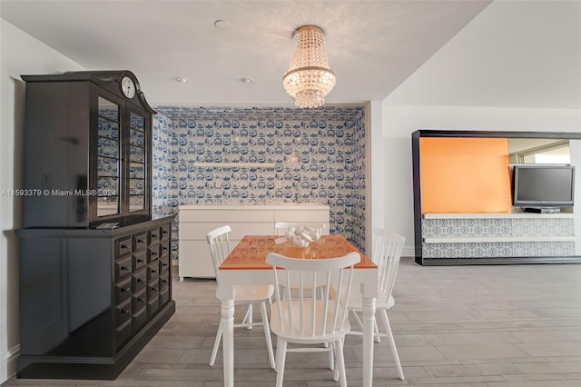 dining space with wood-type flooring and a chandelier