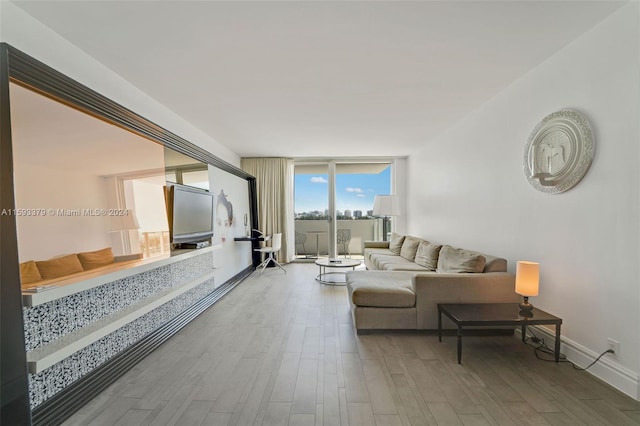 living room with hardwood / wood-style floors and expansive windows