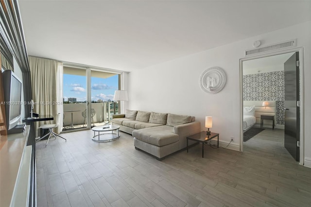 living room featuring wood-type flooring and expansive windows