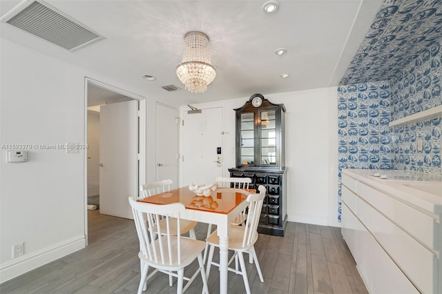 dining area featuring an inviting chandelier and hardwood / wood-style floors