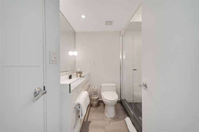 bathroom featuring wood-type flooring, vanity, and toilet