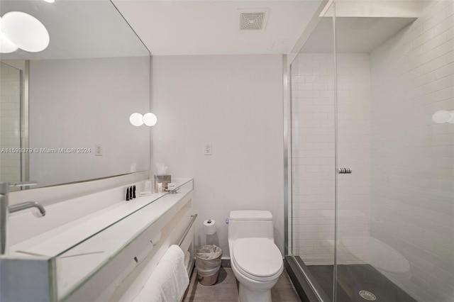 bathroom with walk in shower, tile flooring, vanity, and toilet