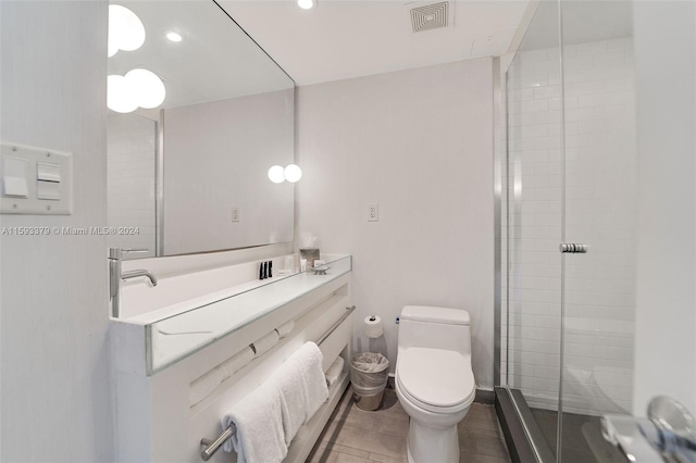 bathroom featuring tile floors, an enclosed shower, toilet, and vanity