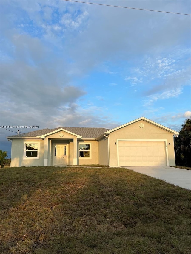 single story home with a front lawn and a garage