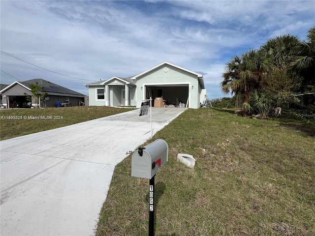 ranch-style home featuring a front yard and a garage