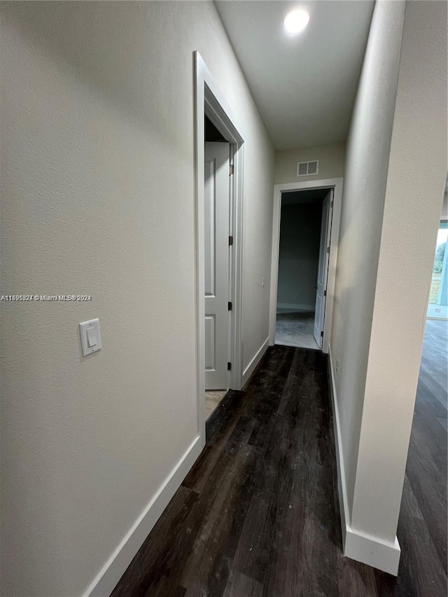 corridor with dark hardwood / wood-style floors