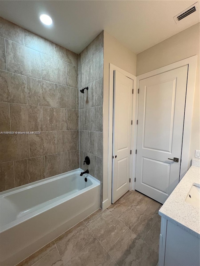 bathroom featuring vanity and tiled shower / bath combo