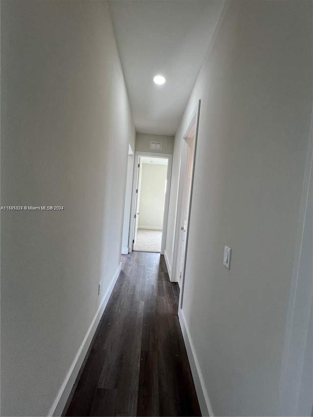 hallway with dark wood-type flooring