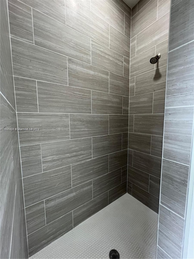 bathroom with a tile shower