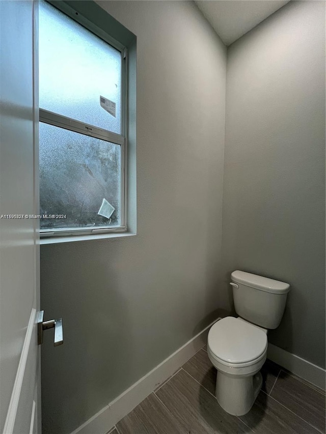 bathroom with wood-type flooring and toilet