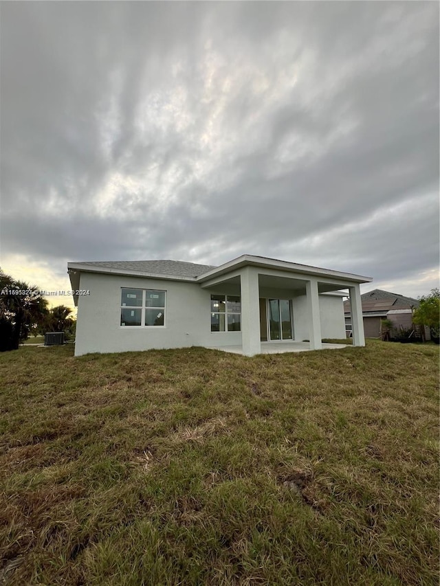 rear view of property with a lawn