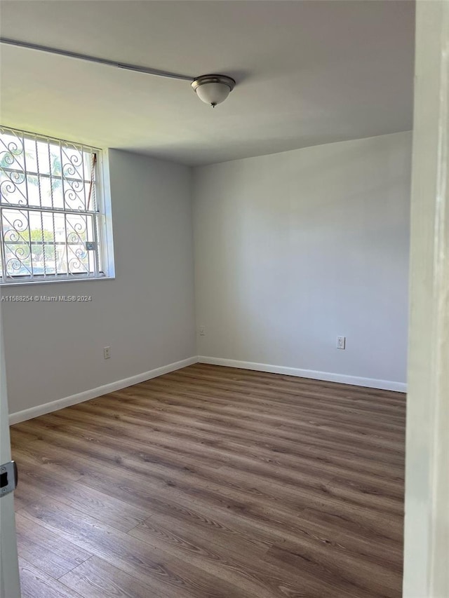 empty room with dark wood-type flooring