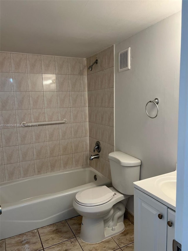 full bathroom featuring vanity, tile patterned flooring, tiled shower / bath combo, and toilet