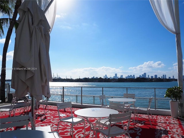 view of patio with a water view and a balcony