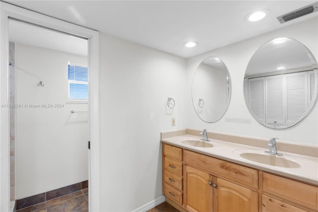 full bath with double vanity, recessed lighting, visible vents, and a sink