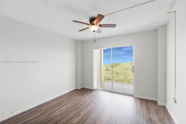 unfurnished room with baseboards, a textured ceiling, wood finished floors, and a ceiling fan