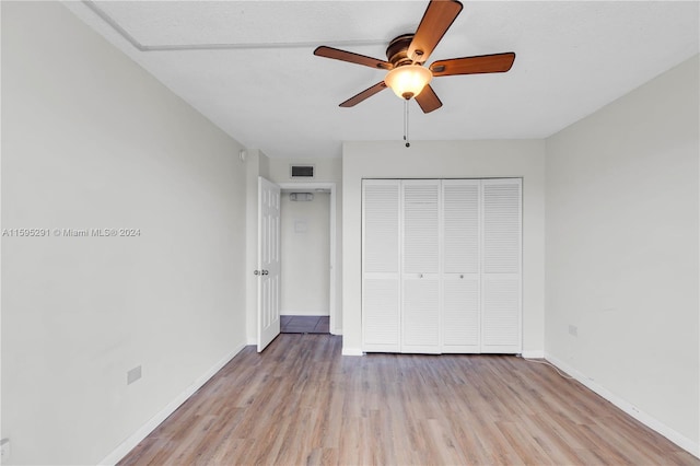 unfurnished bedroom with visible vents, light wood-style flooring, a ceiling fan, a closet, and baseboards